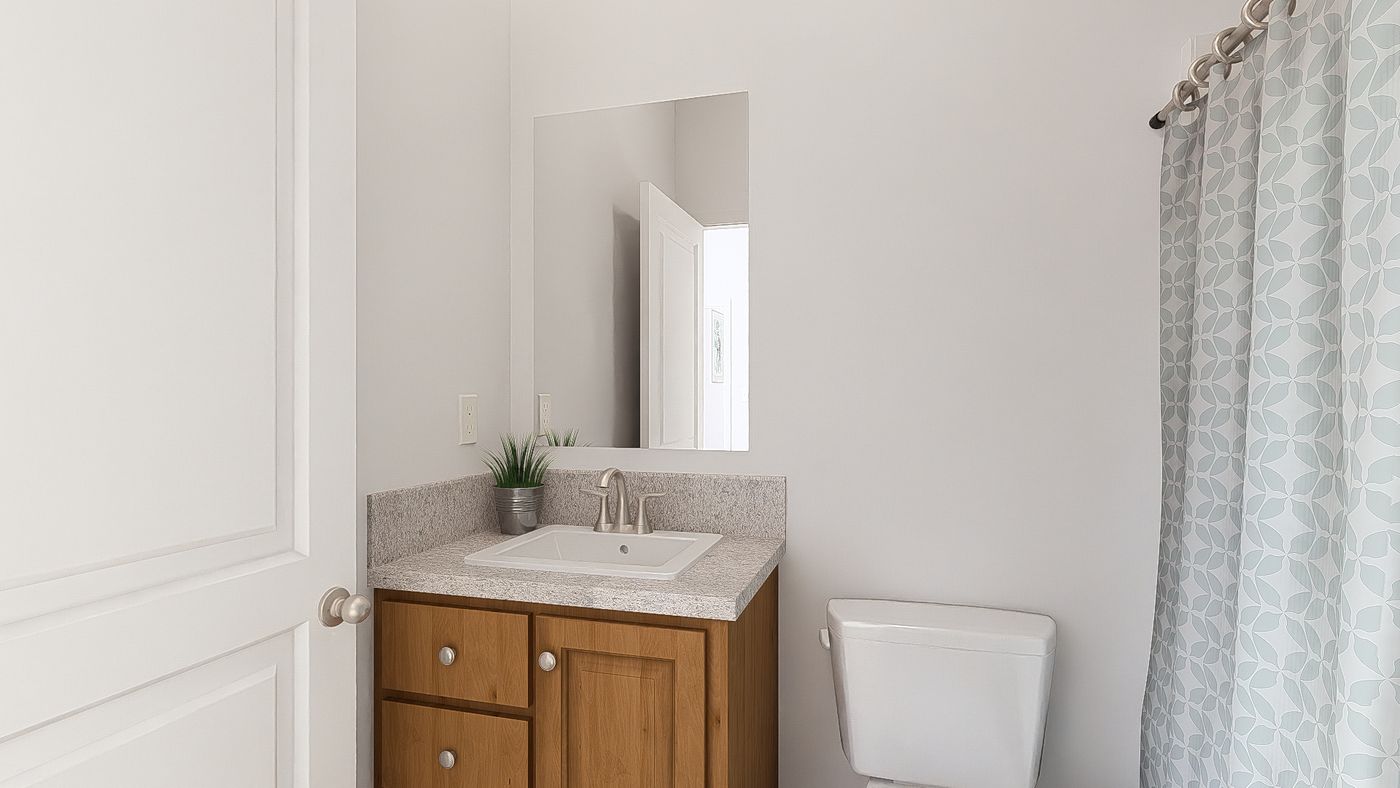 The DRM601M 60' DREAM Primary Bathroom. This Manufactured Mobile Home features 1 bedroom and 2 baths.